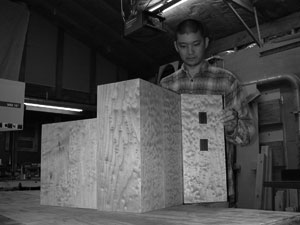 Peter Loh putting the finishing touches on a cabinet